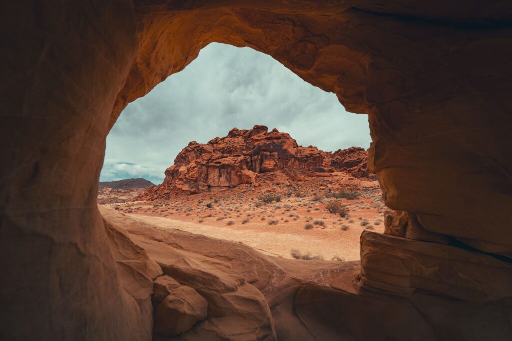 Explore the unique desert landscape through a natural rock opening in Overton, NE.