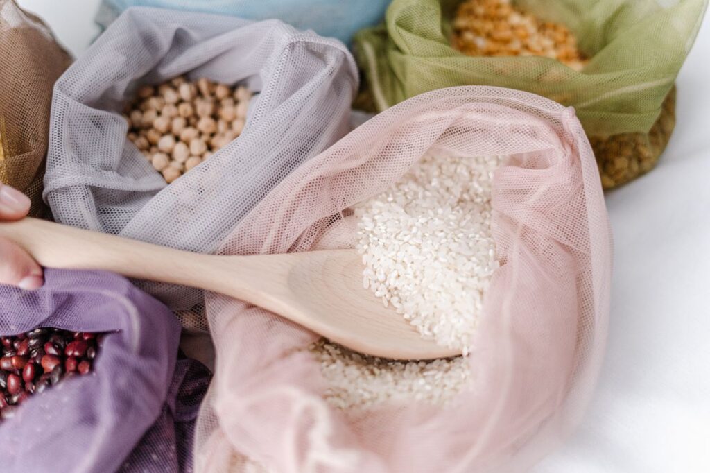 Close-up of eco-friendly reusable bags filled with various grains, promoting zero waste lifestyle.